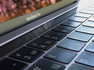 A detailed close-up of a MacBook Pro keyboard, highlighting keys and reflection.
