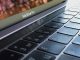 A detailed close-up of a MacBook Pro keyboard, highlighting keys and reflection.